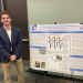 AJ Jefferson standing in front of his research poster