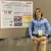 Owen McCulloch standing in front of his research poster